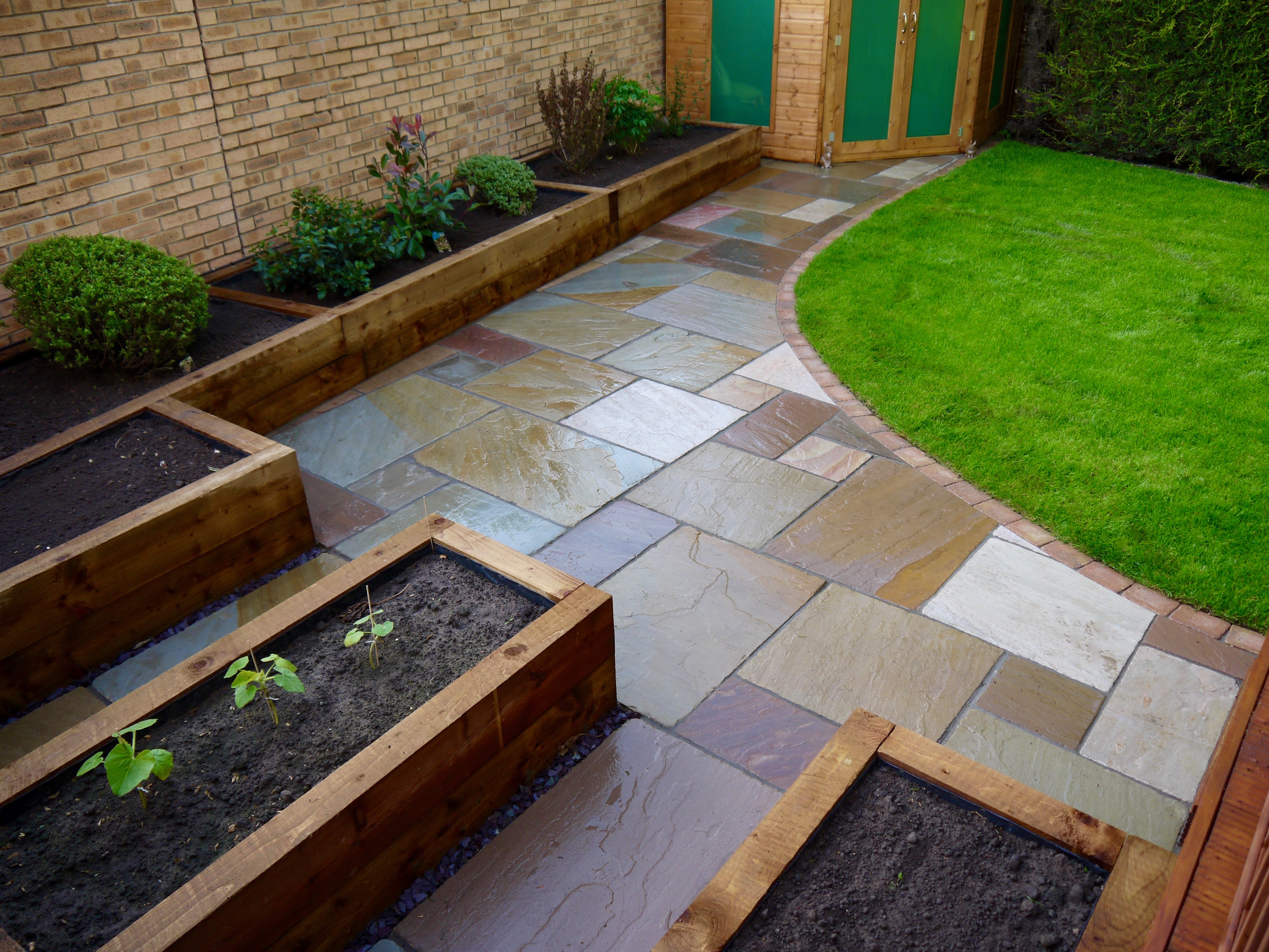 low-maintenance-gardens-raised-sleepers-sandstone-patio-turfing-garden
