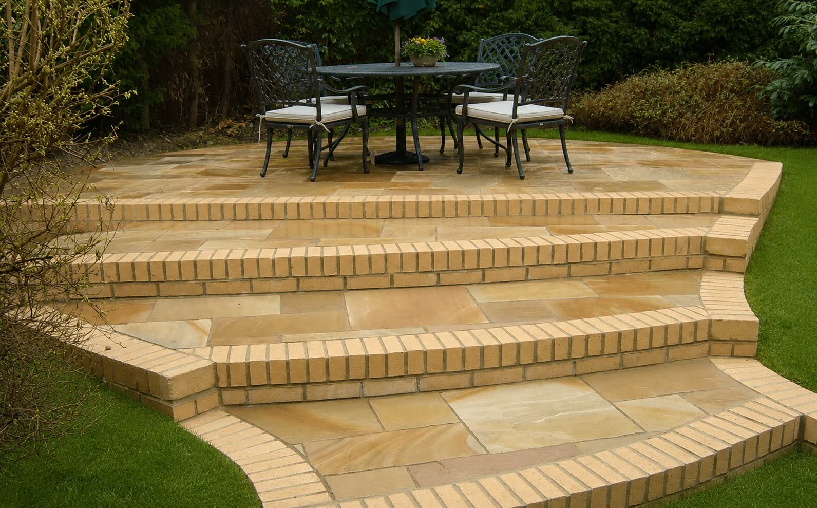 Indian sandstone patio with curved brick steps and improved lawn in Marton Middlesbrough