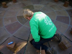 Grouting in, sandstone patio, patio area, paving, garden patio, circular patio, Green Onion Landscaping, Garden design, landscaping, landscaper, Stockton, Fairfield, darlington, Middlesbrough, Teesside, Cleveland