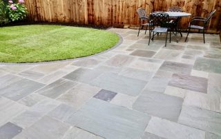 Professional garden landscaping in Stockton with porcelain paving and new lawn by Green Onion Landscaping
