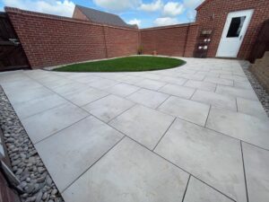low maintenance garden,Porcelain patio area with a beautiful Scotch pebble edge, garden drainage underneath the newly turfed lawn and new close board garden fencing. All installed by professional landscape gardeners Green Onion Landscaping who are based in Stockton on Tees, Teesside, County Durham Mobility friendly garden