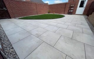 low maintenance garden,Porcelain patio area with a beautiful Scotch pebble edge, garden drainage underneath the newly turfed lawn and new close board garden fencing. All installed by professional landscape gardeners Green Onion Landscaping who are based in Stockton on Tees, Teesside, County Durham Mobility friendly garden
