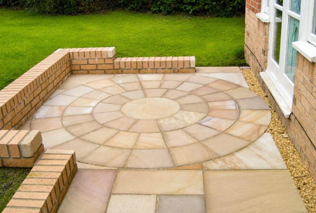 Circular Indian sandstone patio with brick retaining wall in Marton Middlesbrough