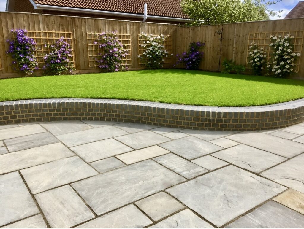Professional turfing, paving, curved brick retaining wall and soft landscaping in Hartburn, Stockton-on-Tees by Green Onion Landscaping.